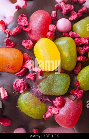Freeze-dried raspberries and jelly beans decorations on top of M&S Fruity Easter Sundae chocolate Easter egg Stock Photo