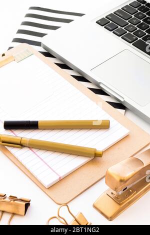 Gold office accessories details in a white desk Stock Photo