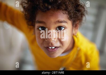 portrait of cute afro-american girl. Afro american cute little girl with curly hair. Stock Photo