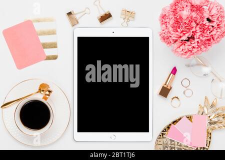 Pink office ipad layout with desk accessories in a white background Stock Photo