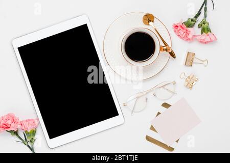 Pink office ipad layout with desk accessories in a white background Stock Photo