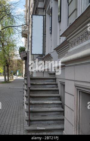 Empty white sign board for advertising text. Blank sign near entrance to cafe. Stock Photo