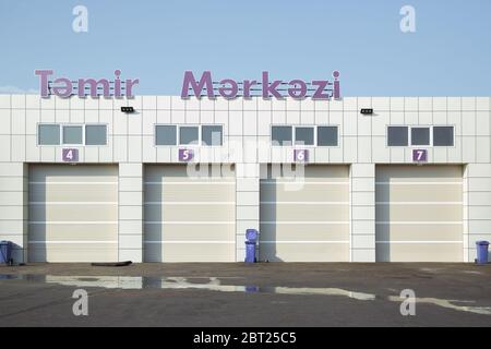 Automatic Electric Roll-up Gate Or Push-up Door In The Modern Building Ground Floor . exterior of a commercial warehouse with white roller doors .Auto Stock Photo