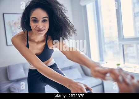 Athletic young female exercising in a room Stock Photo
