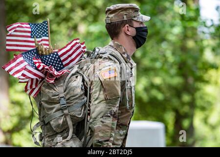 Arlington, United States Of America. 21st May, 2020. Arlington, United States of America. 21 May, 2020. Soldiers with the 3d U.S. Infantry Regiment, wearing PPE, place flags at headstones during Flags-in ceremony at Arlington National Cemetery marking the start of the Memorial Day holiday May 21, 2020 in Arlington, Virginia. Credit: Elizabeth Fraser/DOD/Alamy Live News Stock Photo