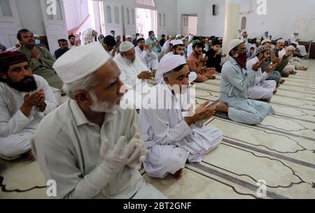 Faithful Muslims offer congregational Friday prayers with SOPs levels on government guidelines of social distancing as preventive measure against the spread of the Coronavirus (COVID-19) during the Holy month of Ramadan-ul- Mubarak, held at Sunehri Masjid in Peshawar on Friday, May 22, 2020. Stock Photo