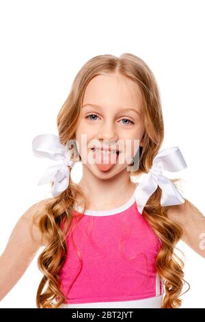 girl in a pink top shows tongue Stock Photo