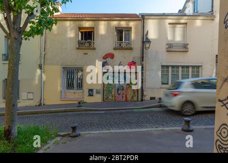 Paris, France - May 17, 2020: General view of various graffitis painted on a small building, taken at the end of the day, Butte-aux-Cailles Stock Photo