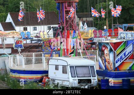 Stourport, Worcestershire, UK. 22nd May, 2020. The Riverside funfair ground on the banks of the River Severn at Stourport is deserted on the eve of a traditionally busy Bank Holiday weekend and school half term. The rides are folded away and dormant when normally teeming with thrill-seeking children and teenagers. Credit: Peter Lopeman/Alamy Live News Stock Photo