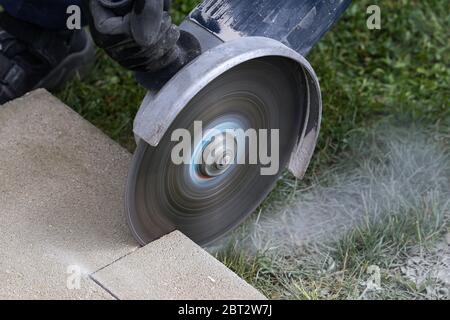 Industrial construction worker using a professional angle grinder Stock Photo