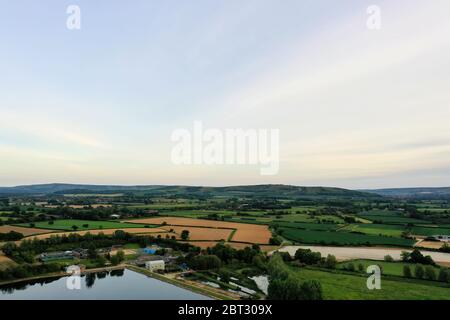 beautiful lush colorful countryside aerial landscape photo, with lake fields and hills in the background Stock Photo