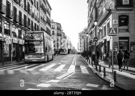 Tourist Bus in Calle de Toledo Madrid Spain in the afternoon near a zebra crossing. Stock Photo