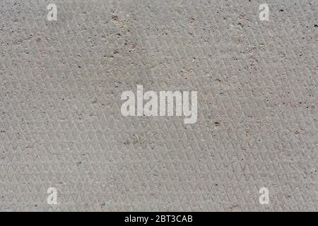 seamless texture and background of old flat dry concrete surface with diamond pattern and signs of light wearing Stock Photo
