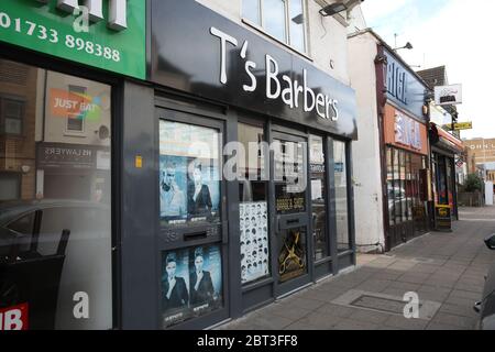 Peterborough, UK. 22nd May, 2020. Day Sixty of Lockdown, in Peterborough. The T's Barbers shop remains closed. Even though there has been a partial lifting of lockdown, there are still many shops that have to remain closed, including barbers and hairdresser salons. COVID-19 Coronavirus lockdown, Peterborough, Cambridgeshire, UK, on May 22, 2020 Credit: Paul Marriott/Alamy Live News Stock Photo