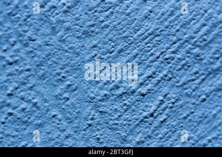 Close-up of a fairly rough blue colored wall with small lumps Stock Photo