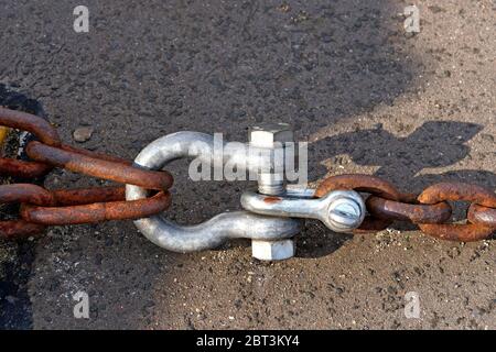 Black metal eyelet in which a shackle is fastened Stock Photo