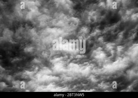 Background Texture of dark black and white ominous storm clouds. Stock Photo
