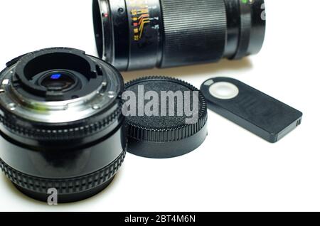 Set of old two photo lenses and remote controller isolated on white background Stock Photo