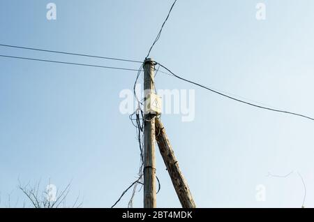 old wooden electric pole gainst the sky Stock Photo