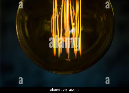 Beautiful women hand on Edison type bulbs Stock Photo