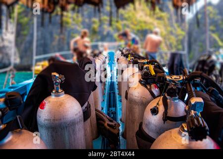 Group of scuba divers preparing for scuba diving on a boat full of gear, Phi Phi Islands, Thailand Stock Photo