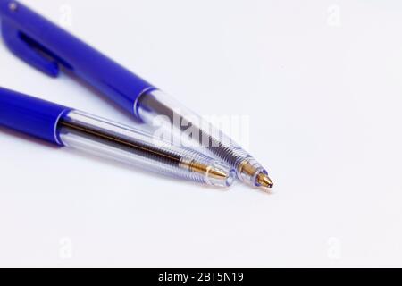 two plain blue ink pens on white background Stock Photo