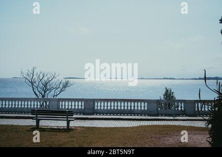 A peaceful and quiet view from a bench looking over Rio de La Plata in the historical site of Colonia del Sacramento. Stock Photo