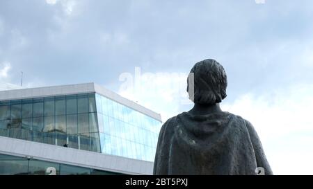 Oslo, Norway - May 22, 2019: The bronze statue of soprano Kirsten Flagstad is standing in front of the National Oslo Opera house near the Oslo Fjord. Stock Photo