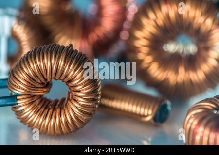 Copper coil and parts of electrical installation with blurred background Stock Photo