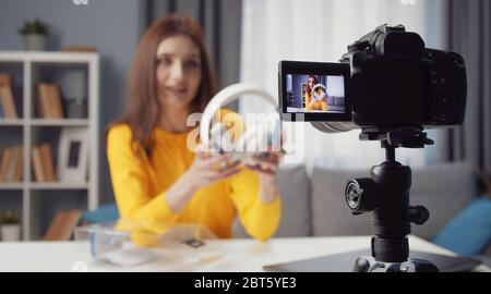 Female vlogger recording headphones review Stock Photo