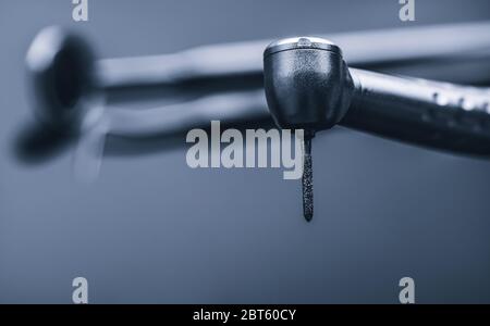 Macro of shiny metal dental drill tool on light gray background Stock Photo