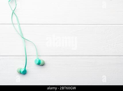 Azure silicon earphones on living room floor, with place for design Stock Photo