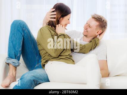 Beatiful women and her husband are relaxing on the couch at holidays Stock Photo