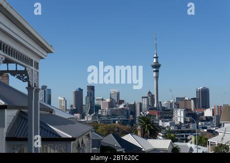 Auckland New Zealand - May 22 2020; City central business district and landmark Skytower in distance viewed from Ponsonby across roof tops of villa ho Stock Photo