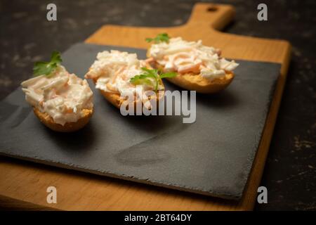 three rolls with American salad on a cutting board Stock Photo