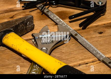 Tools for repair and building. Hummer, adjustable spanner, ruler. Instruments on rustic wooden table with copy space Stock Photo