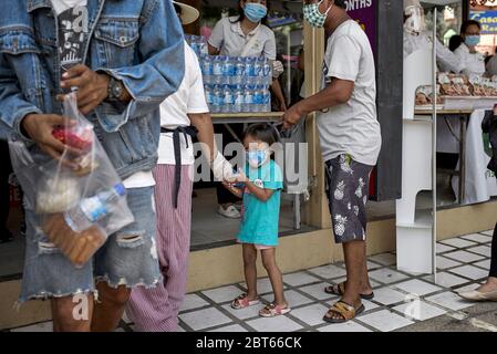 Covid-19 Child.  Free food handout to people in need due to loss of income from Coronavirus funded by local businesses in Pattaya Thailand Asia Stock Photo