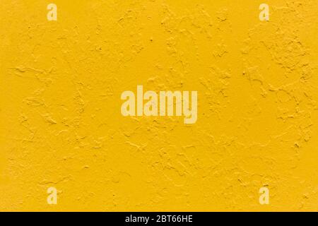 seamless texture of flat thick painted yellow surface under direct sunlight Stock Photo
