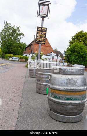 Ashford, Kent, UK. 23rd May, 2020. Friends and neighbours in the village of Hamstreet near Ashford in Kent occupy their time with chores about the house. The local village pub, The Kings Head has been closed now for 2 months, it will remain closed until the 3rd step in the governments guidelines to reopen business. Empty beer barrels sit in front of the entrance to the pub. ©Paul Lawrenson 2020, Photo Credit: Paul Lawrenson/Alamy Live News Stock Photo