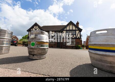 Ashford, Kent, UK. 23rd May, 2020. Friends and neighbours in the village of Hamstreet near Ashford in Kent occupy their time with chores about the house. The local village pub, The Kings Head has been closed now for 2 months, it will remain closed until the 3rd step in the governments guidelines to reopen business. Empty beer barrels sit in front of the entrance to the closed pub preventing entry. ©Paul Lawrenson 2020, Photo Credit: Paul Lawrenson/Alamy Live News Stock Photo