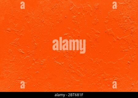 seamless texture of flat thick painted lush lava color surface under direct sunlight - new paint over fragments of old peeled one Stock Photo
