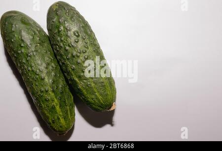Aerial Shot Of A Group Of Two Fresh Green Cucumbers On White Background Stock Photo