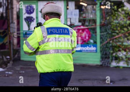 Unrecognizable local police agent. Romanian police man, traffic police man (Politia Rutiera) directing traffic in Bucharest, Romania, 2020 Stock Photo