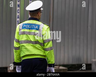 Unrecognizable local police agent. Romanian police man, traffic police man (Politia Rutiera) directing traffic in Bucharest, Romania, 2020 Stock Photo