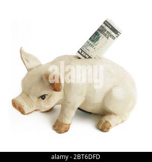 US 5 Dollar note in the slot of a piggy bank Stock Photo