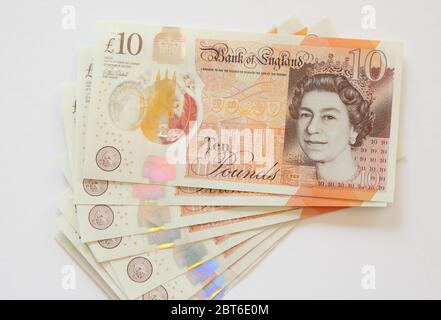 Front of British ten pound notes fanned out on white background Stock Photo