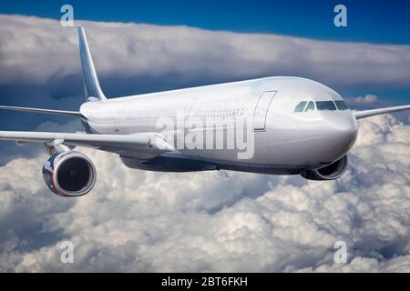 Passenger Airliner flying in the clouds Stock Photo
