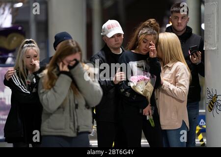 Manchester, UK. 22nd May, 2020. Members of the public stand by a memorial to the victims of the Manchester Arena Bomb at Manchester Victoria Railway Station as the 3rd Anniversary of the terror attack is marked with a minuteÕs silence, Manchester, UK. Credit: Jon Super/Alamy Live News. Stock Photo