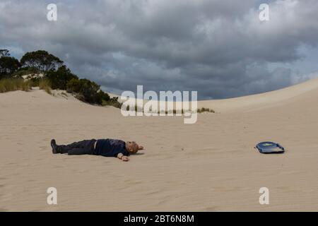 Kangaroo Island, Australia - March 9th, 2020: A man after a sand surfing accident in Kangaroo Island, Australia. Stock Photo