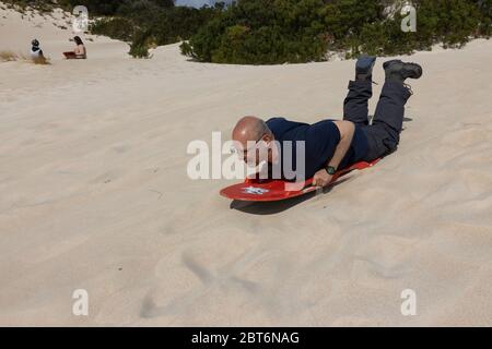 Kangaroo Island, Australia - March 9th, 2020: A man sand surfing in Kangaroo Island, Australia. Stock Photo